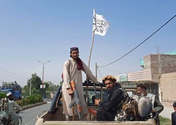 Taliban fighters drive an Afghan National Army (ANA) vehicle through the streets of Laghman province on August 15, 2021. (Photo by - / AFP)