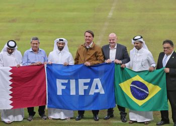 Hassan al-Thawadi (3rd-L), Secretary General of Qatar World Cup's Supreme Committee for Delivery and Legacy, Brazilian President Jair Bolsonaro (C), FIFA president Gianni Infantino (3rd-R), pose for a group picture at the Lusail Stadium, the 80,000-capacity venue that will host the FIFA World Cup final in December 2022, around 20 kilometres north of the Qatari capital Doha on November 17, 2021. (Photo by KARIM JAAFAR / AFP)