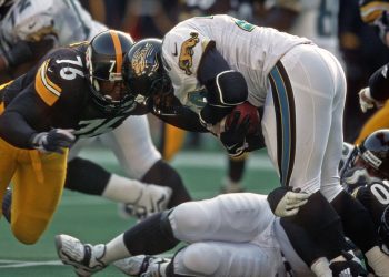 PITTSBURGH, PA - NOVEMBER 22:  Defensive lineman Kevin Henry #76 and linebacker Earl Holmes #50 of the Pittsburgh Steelers tackle running back Fred Taylor #28 of the Jacksonville Jaguars during a game at Three Rivers Stadium on November 22, 1998 in Pittsburgh, Pennsylvania.  The Steelers defeated the Jaguars 20-15.  (Photo by George Gojkovich/Getty Images)