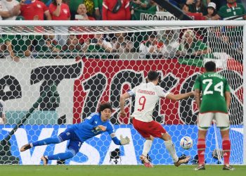 DOHA, QATAR - NOVEMBER 22: Robert Lewandowski of Poland shoots a penalty which is saved by Guillermo Ochoa of Mexico during the FIFA World Cup Qatar 2022 Group C match between Mexico and Poland at Stadium 974 on November 22, 2022 in Doha, Qatar. (Photo by Dan Mullan/Getty Images)