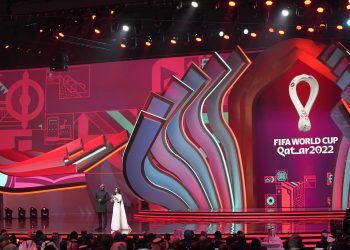Actor Idris Elba, left, and sports broadcaster Reshmin Chowdhury arrive on stage to host the 2022 soccer World Cup draw at the Doha Exhibition and Convention Center in Doha, Qatar, Friday, April 1, 2022. (AP Photo/Darko Bandic)