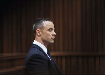 South African Paralympic sprinter Oscar Pistorius sits in the dock during the testimony of a defence witness at his murder trial at the high court in Pretoria on May 6, 2014. Pistorius's defence team said on May 6 it could wrap up its case within a week, his lawyer has told the athlete's murder trial. "I even believe we may end the defence case by Tuesday next week," defence lawyer Barry Roux said.  AFP PHOTO / POOL / Mike Hutchings          (Photo credit should read MIKE HUTCHINGS/AFP via Getty Images)
