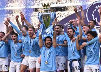 Manchester City's German midfielder Ilkay Gundogan lifts the trophy as Manchester City players celebrate winning the title at the presentation ceremony following the English Premier League football match between Manchester City and Chelsea at the Etihad Stadium in Manchester, north west England, on May 21, 2023. Manchester City won the Premier League for the fifth time in six seasons on Saturday, taking a first step to a possible golden treble of trophies as second-placed Arsenal lost 1-0 at Nottingham Forest. (Photo by Oli SCARFF / AFP) / RESTRICTED TO EDITORIAL USE. No use with unauthorized audio, video, data, fixture lists, club/league logos or 'live' services. Online in-match use limited to 120 images. An additional 40 images may be used in extra time. No video emulation. Social media in-match use limited to 120 images. An additional 40 images may be used in extra time. No use in betting publications, games or single club/league/player publications. /