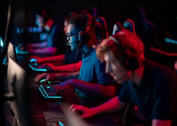 Professional esports players at an online game tournament. The cyber team plays computers and trains.